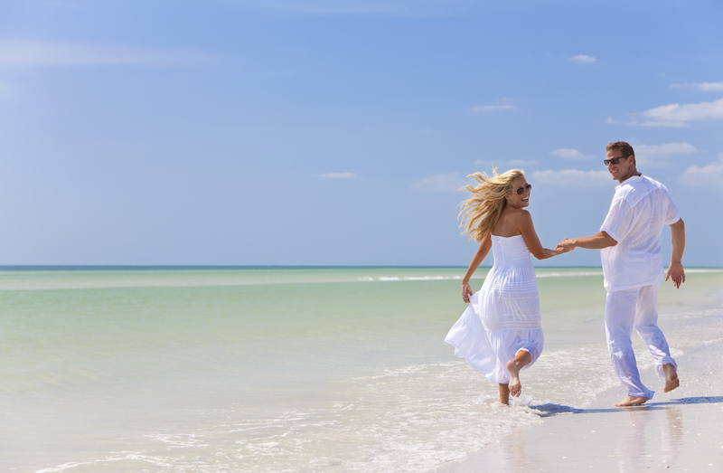 young-couple-holding-hands-on-a-tropical-beach-01564189730